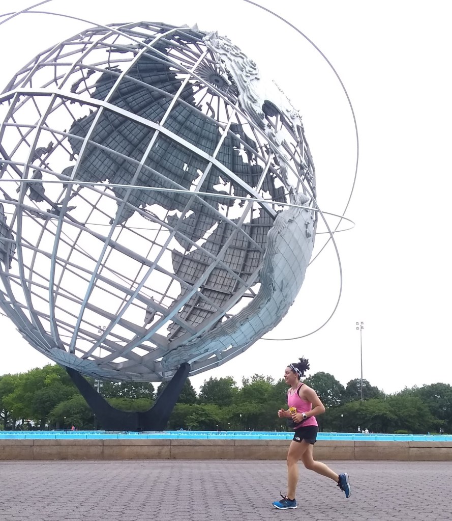 Author running next to the globe at Flushing Meadows Park.